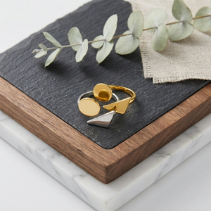 Dual geometric band featuring gold and silver shapes on slate with eucalyptus accent, ideal for modern styling