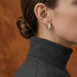Woman Wearing Gold Double Row Diamond Cluster Huggie Earrings with Dark Grey Turtleneck and Updo Hairstyle - Double_Row_Diamond_Cluster_Huggie_Earrings_Gold - J. Collins Jewelry 