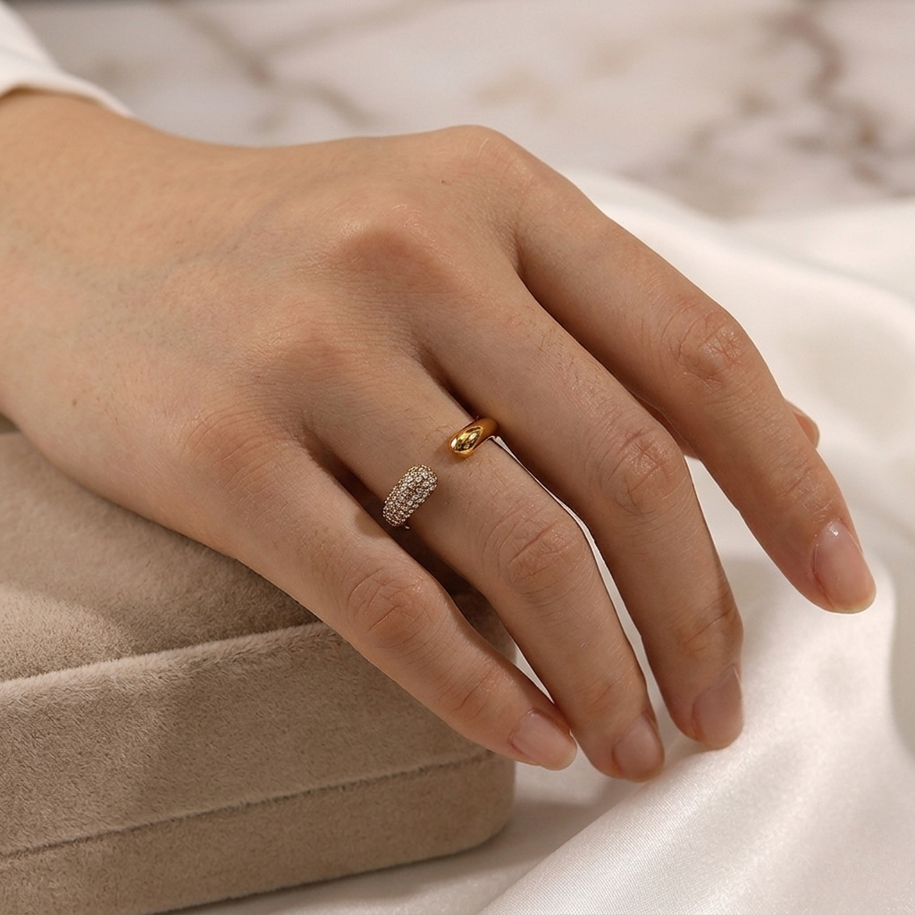 Curved Pavé Ring on hand, gold band with pavé diamonds, elegant style, resting on a cushion with a white background.