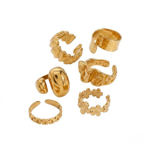 Gold textured coil and floral rings set on a white background