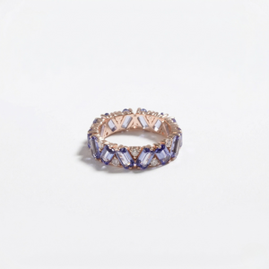 14K rose gold ring with lab-created sapphires in a geometric setting on a plain background