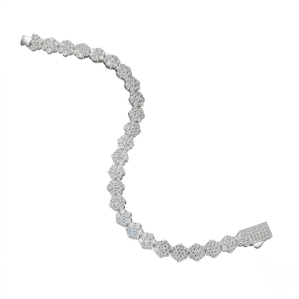 Sterling silver tennis bracelet with linked floral cluster cubic Moissanite stations and an iced-out box clasp unclasped in an S-curve layout on a plain white background by J.Collins

