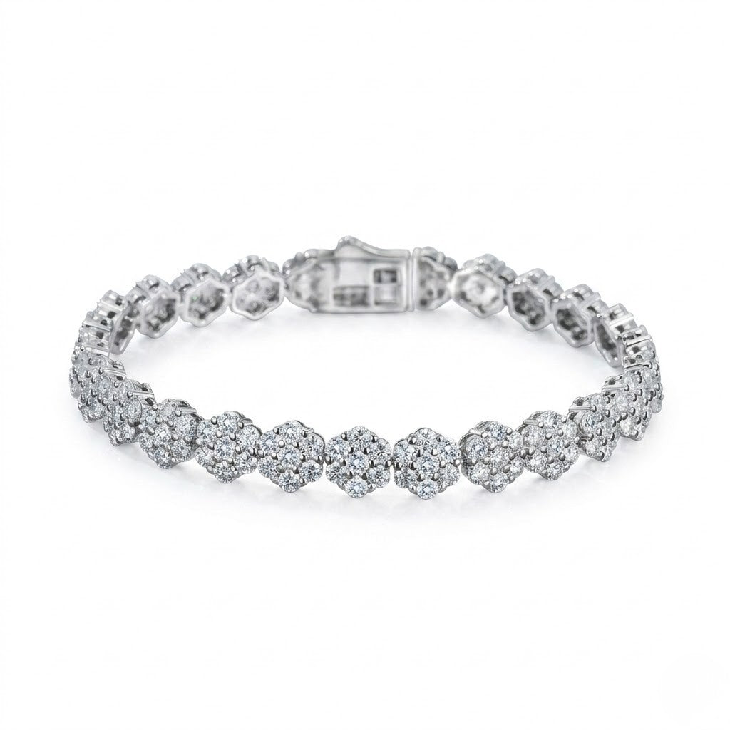 Sterling silver tennis bracelet with circular floral cluster cubic Moissanite links and a secure box clasp angled on a plain white background by J.Collins
