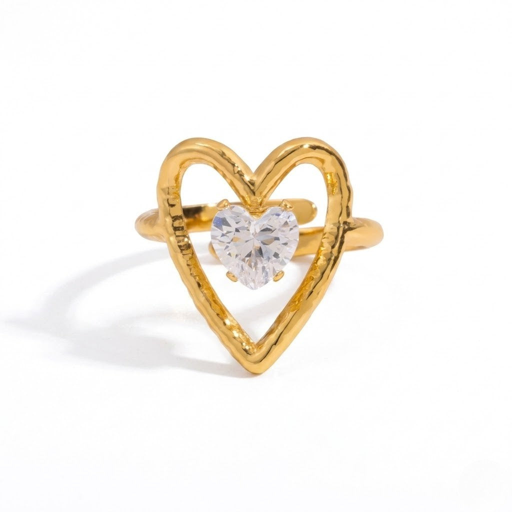 Heart-shaped gold ring with a heart-shaped clear gemstone centerpiece