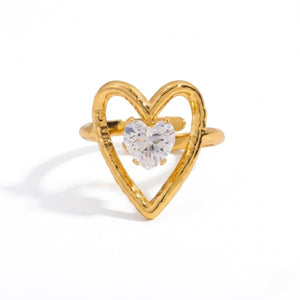 Heart-shaped gold ring with a heart-shaped clear gemstone centerpiece