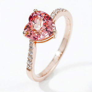 Heart-shaped pink gemstone ring in 18K rose gold with diamond accents