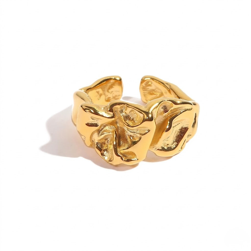 Gold textured open band ring with abstract swirling design on a white background