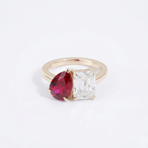14K yellow gold ring with pear-shaped red ruby and emerald-cut clear moissanite stones