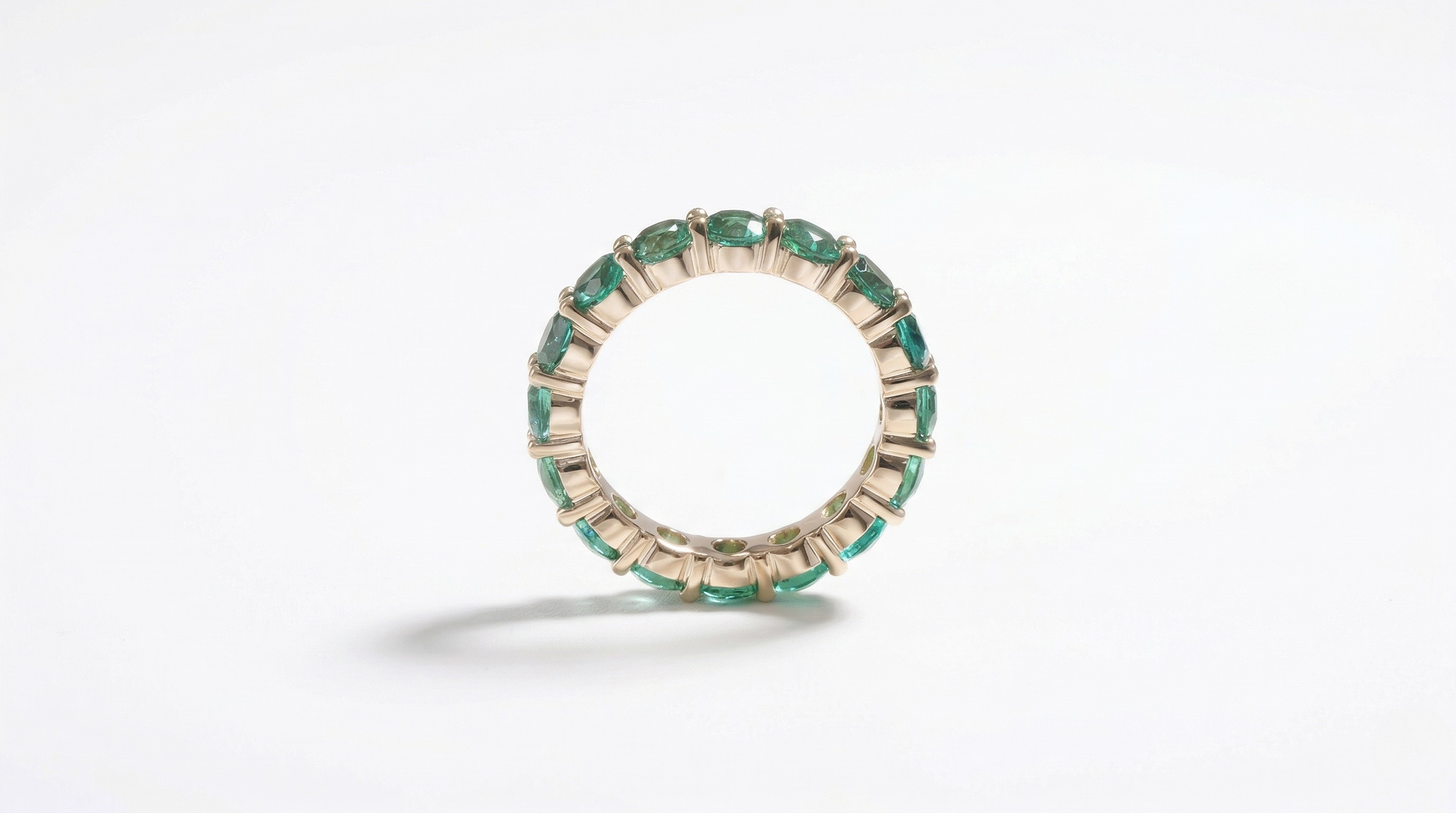 14K yellow gold ring with lab-created emeralds in a continuous band style