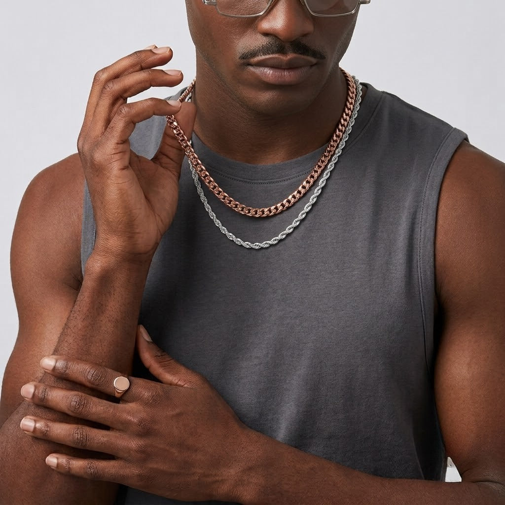 Male model layering a rose gold cuban link chain with a sterling silver rope chain necklace | J.Collins Jewelry