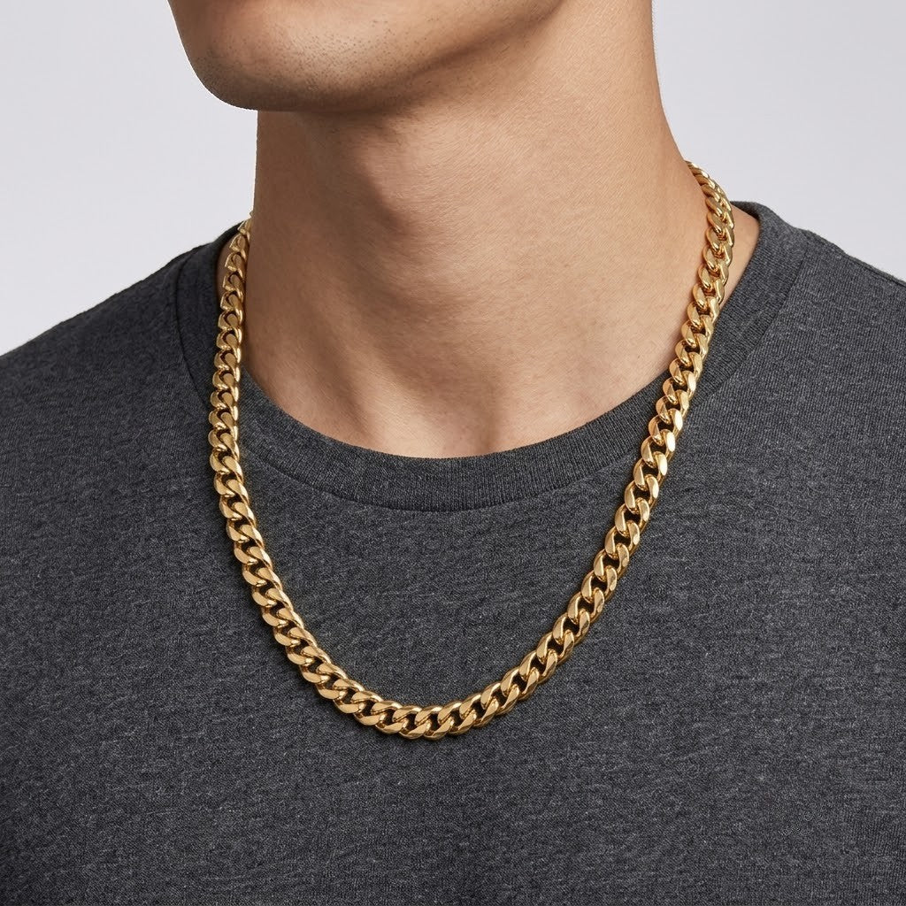 Close-up profile view of a male model wearing a thick yellow gold cuban link chain necklace | J.Collins Jewelry