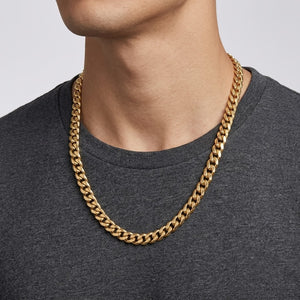 Close-up profile view of a male model wearing a thick yellow gold cuban link chain necklace | J.Collins Jewelry
