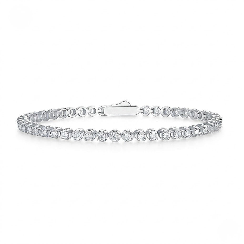 Classic single-row sterling silver tennis bracelet set with round cubic Moissanite crystals and a secure clasp shown on a plain white background by J.Collins
