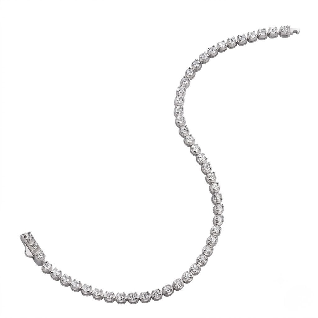 Classic single-row sterling silver tennis bracelet set with round cubic Moissanite crystals unclasped in an S-curve layout on a plain white background by J.Collins

