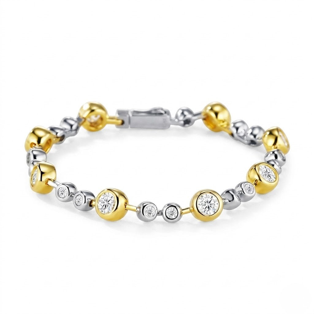 Two-tone gold and sterling silver station bracelet set with bezel-set round cubic Moissanite crystals shown on a plain white background by J.Collins
