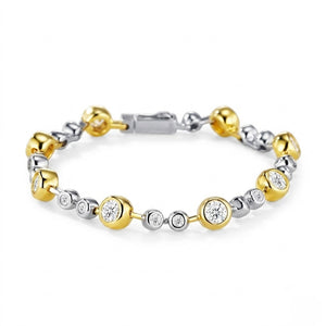 Two-tone gold and sterling silver station bracelet set with bezel-set round cubic Moissanite crystals shown on a plain white background by J.Collins
