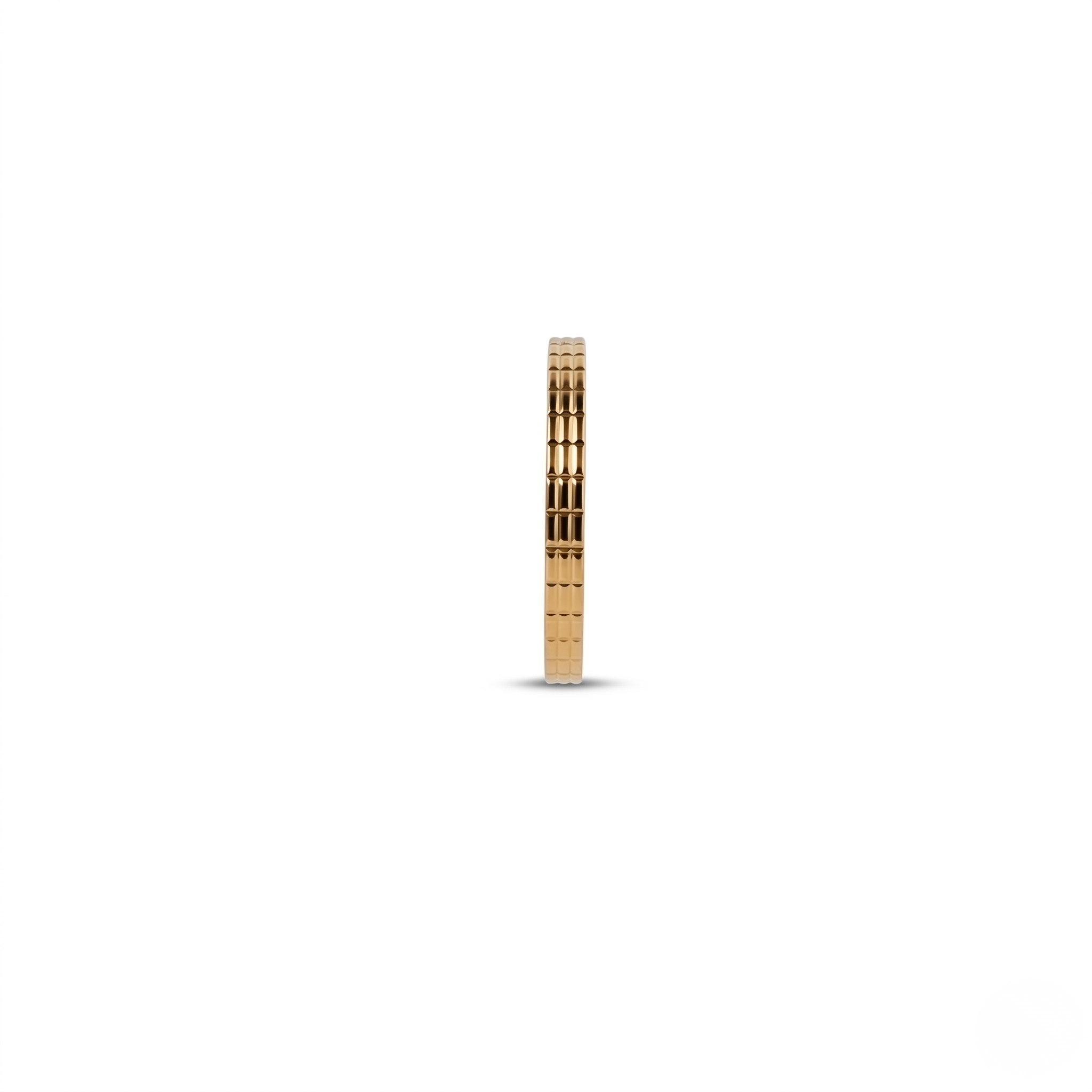 Gilded gold bracelet with a textured pattern, displayed on a white background, side view.