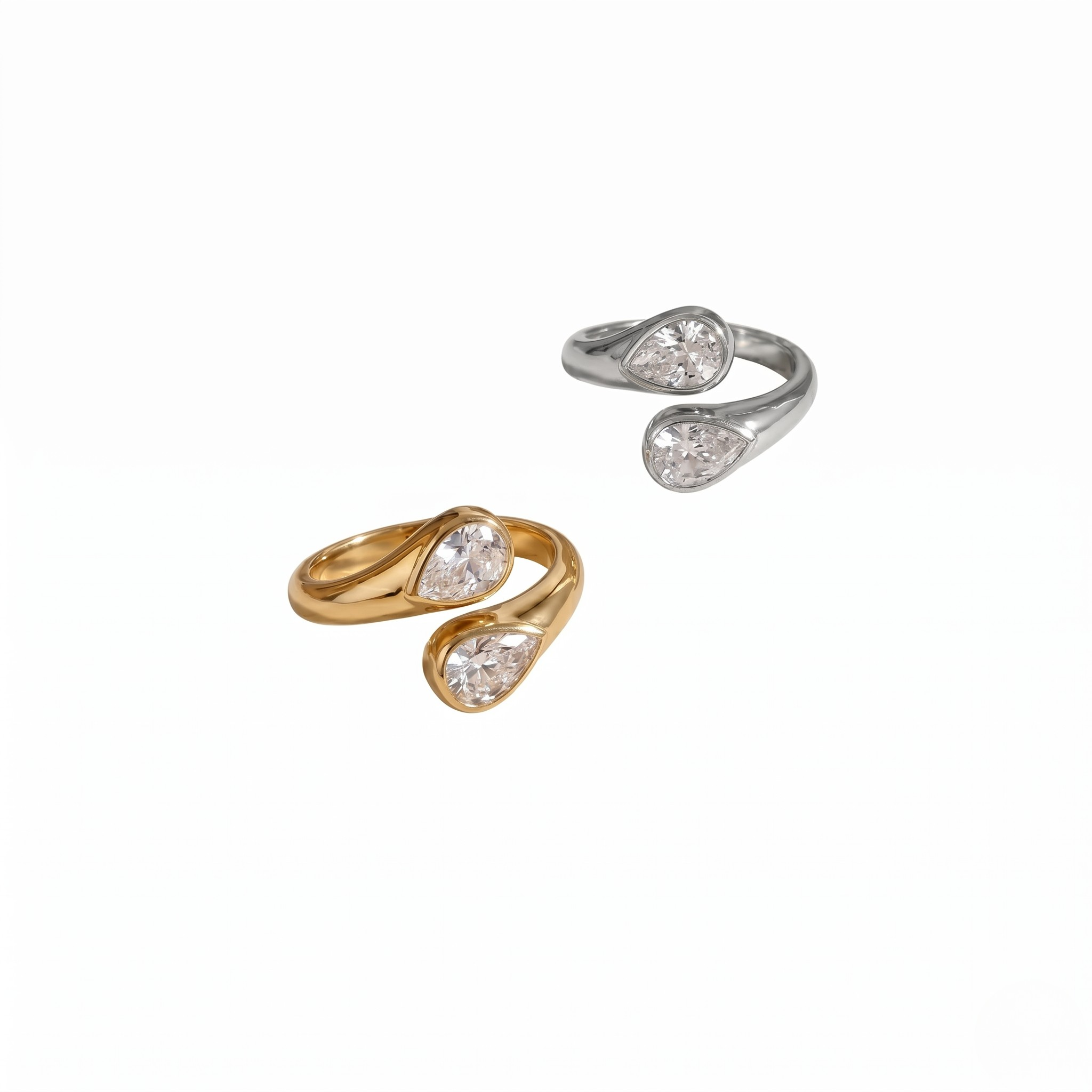 Gold and silver modern teardrop rings featuring dual pear-shaped stones.