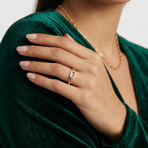Gold Sleek Link Band on woman's hand wearing a matching chain necklace and green velvet top