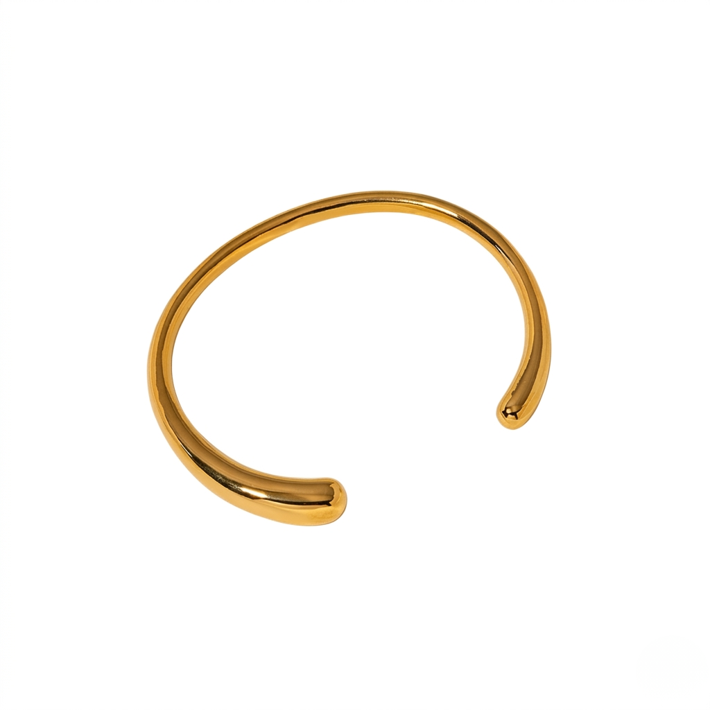 Gold open cuff bracelet by J.Collins Jewelry on white background
