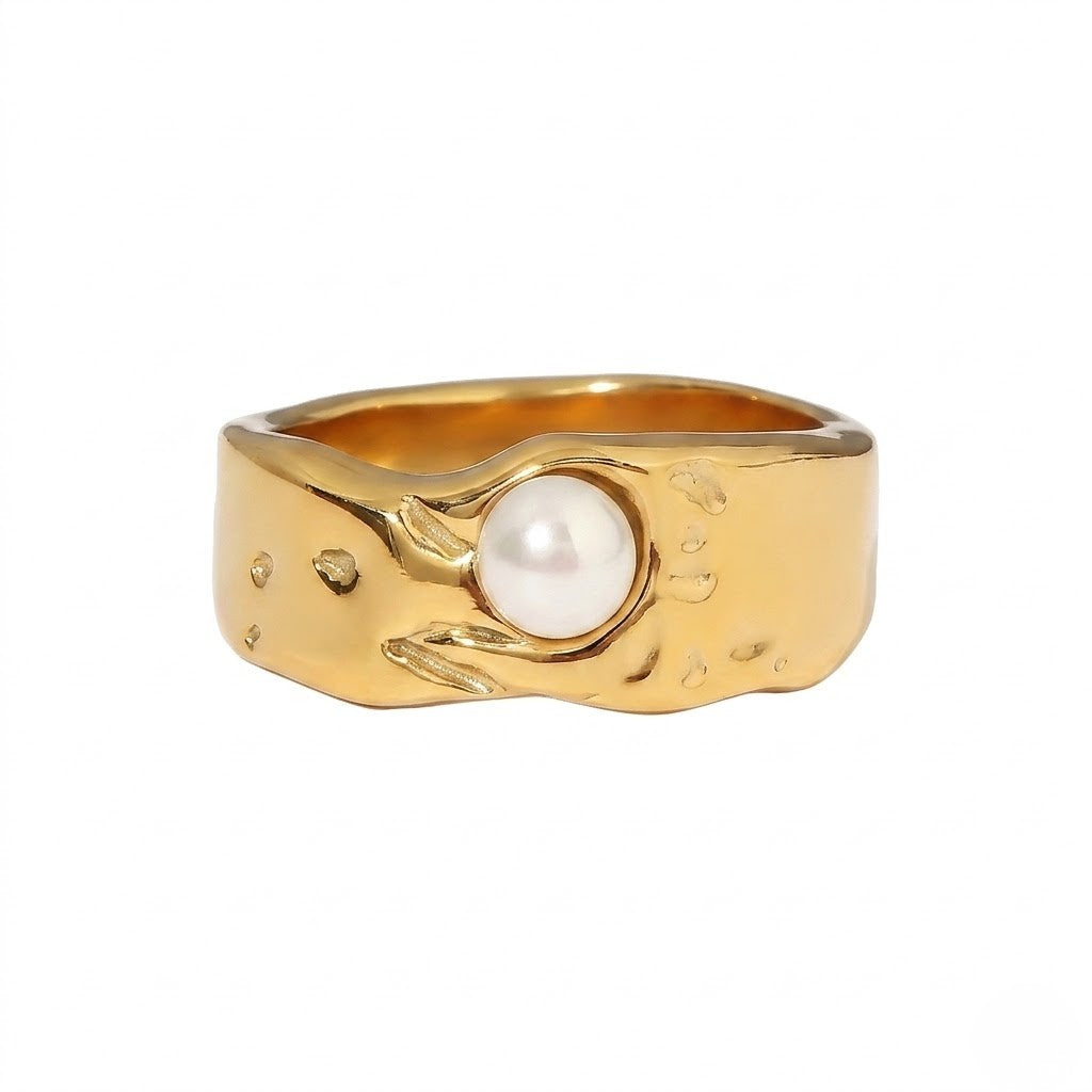 Gold ring with textured band featuring a central white pearl from J.Collins Jewelry