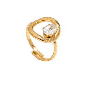 Gold ring with a textured, open crown design and a central sparkling oval stone on a white background