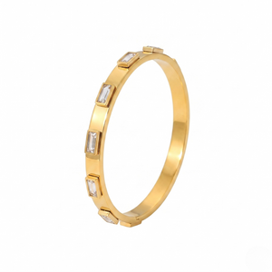 Gold bangle set with rectangular clear gemstones in an elegant design