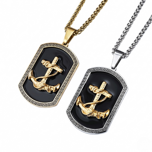 Gold and silver anchor pendants with black enamel on chains, featuring a Greek key pattern border
