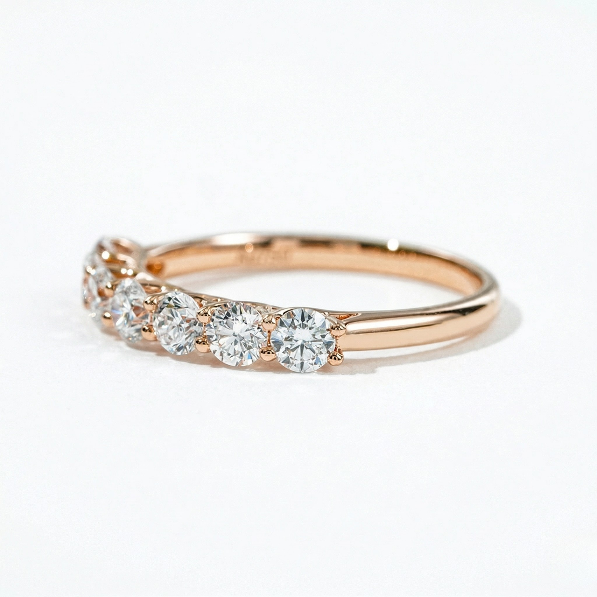 18K rose gold ring with seven 3.0mm lab diamonds in a princess setting