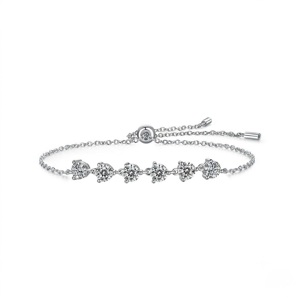Sterling silver adjustable bolo slider bracelet featuring round cubic Moissanite stone stations shown at an angle on a plain white background by J.Collins
