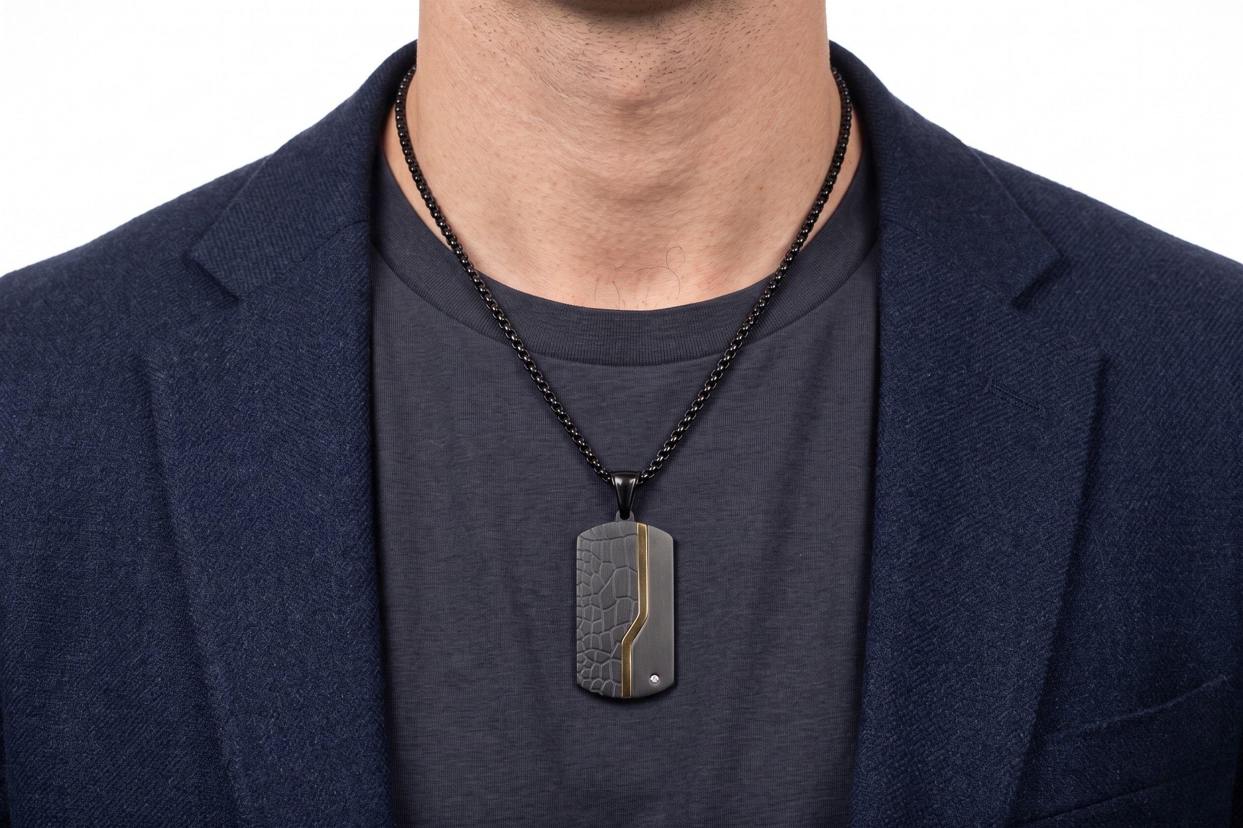 Person wearing a dark blue blazer and black shirt with a Black crocodile-patterned pendant with gold accent - Apex Tag Black Gold - J. Collins Jewelry 