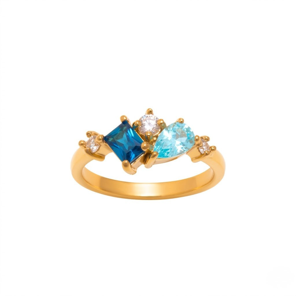 Gold ring with blue and teal gemstones in a cluster setting, featuring a sleek band design.