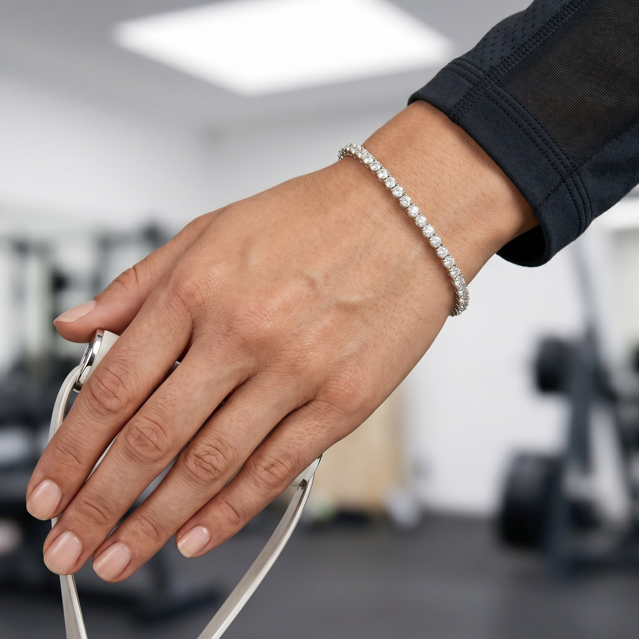 Tennis bracelet with diamonds on a wrist, showing a lifestyle context in a gym setting.