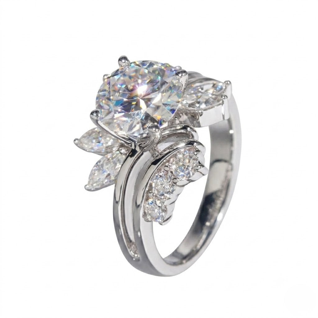 Sterling silver ring featuring a round center cubic Moissanite stone flanked by marquise accents shown at an angle on a plain white background by J.Collins
