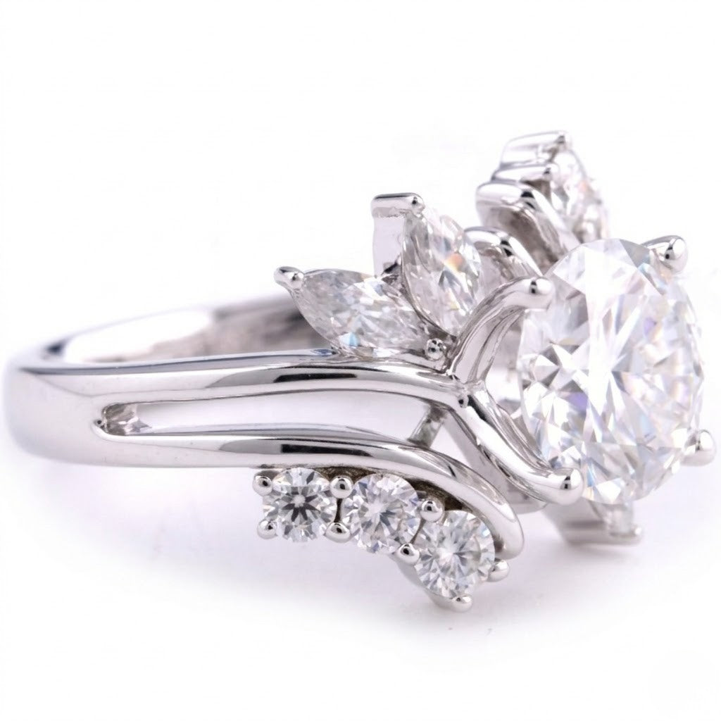 Sterling silver ring featuring a round center cubic Moissanite stone flanked by marquise accents shown close-up on a plain white background by J.Collins
