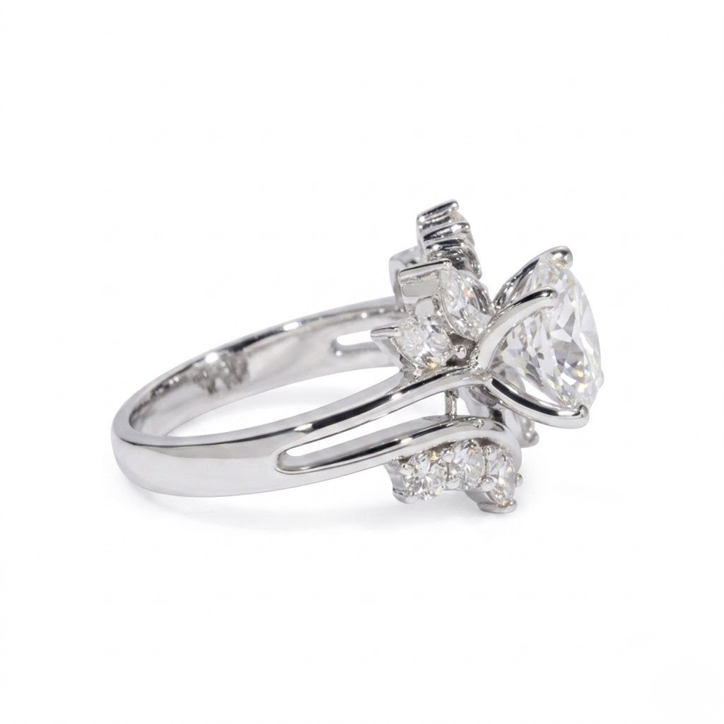 Sterling silver ring featuring a round center cubic Moissanite stone flanked by marquise accents shown close-up on a plain white background by J.Collins
