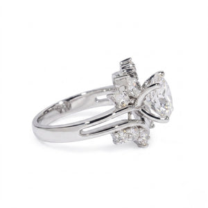 Sterling silver ring featuring a round center cubic Moissanite stone flanked by marquise accents shown close-up on a plain white background by J.Collins

