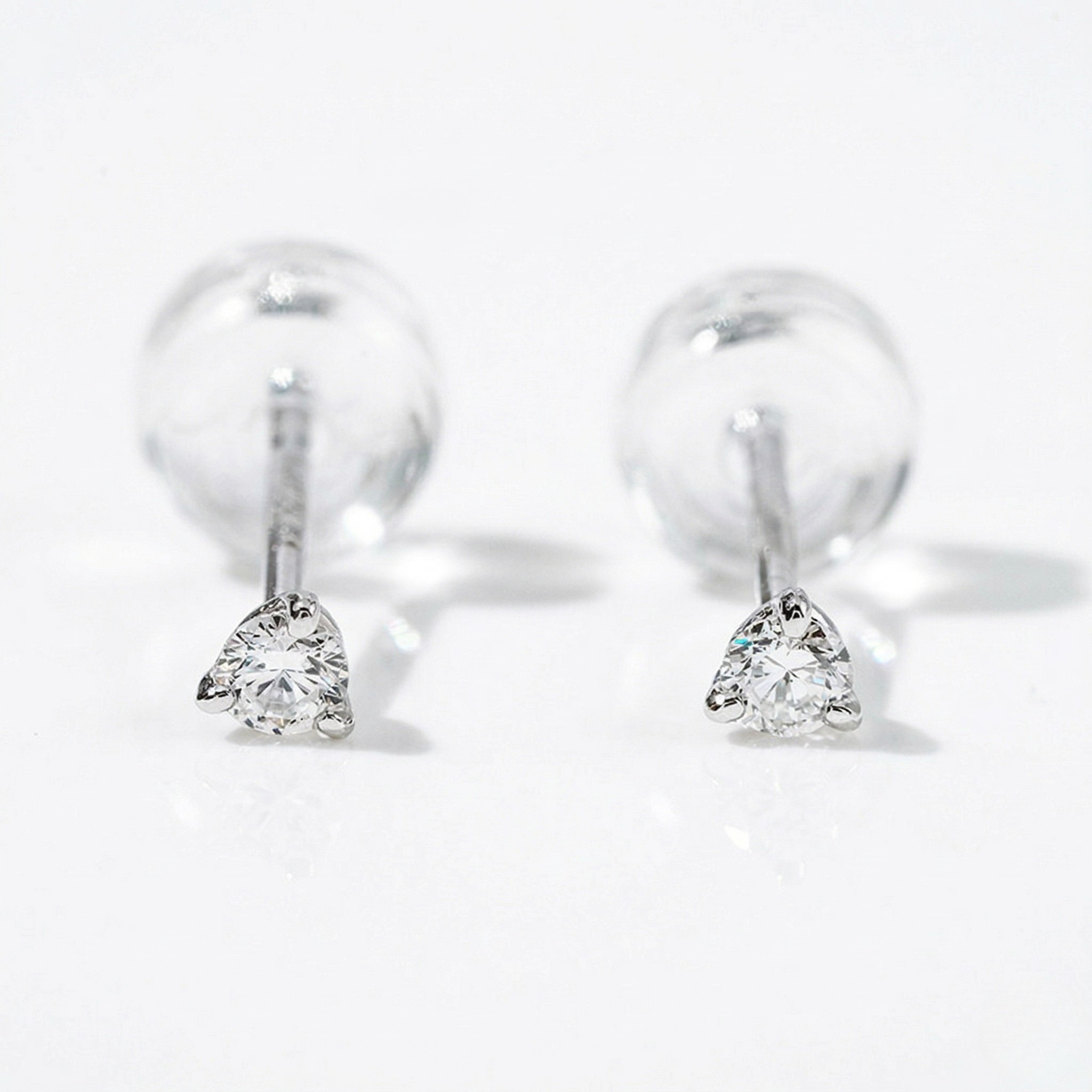 Pair of silver earrings with clear gemstones on a white background - Diamond Earrings Martini 0.05ct - J. Collins Jewelry 