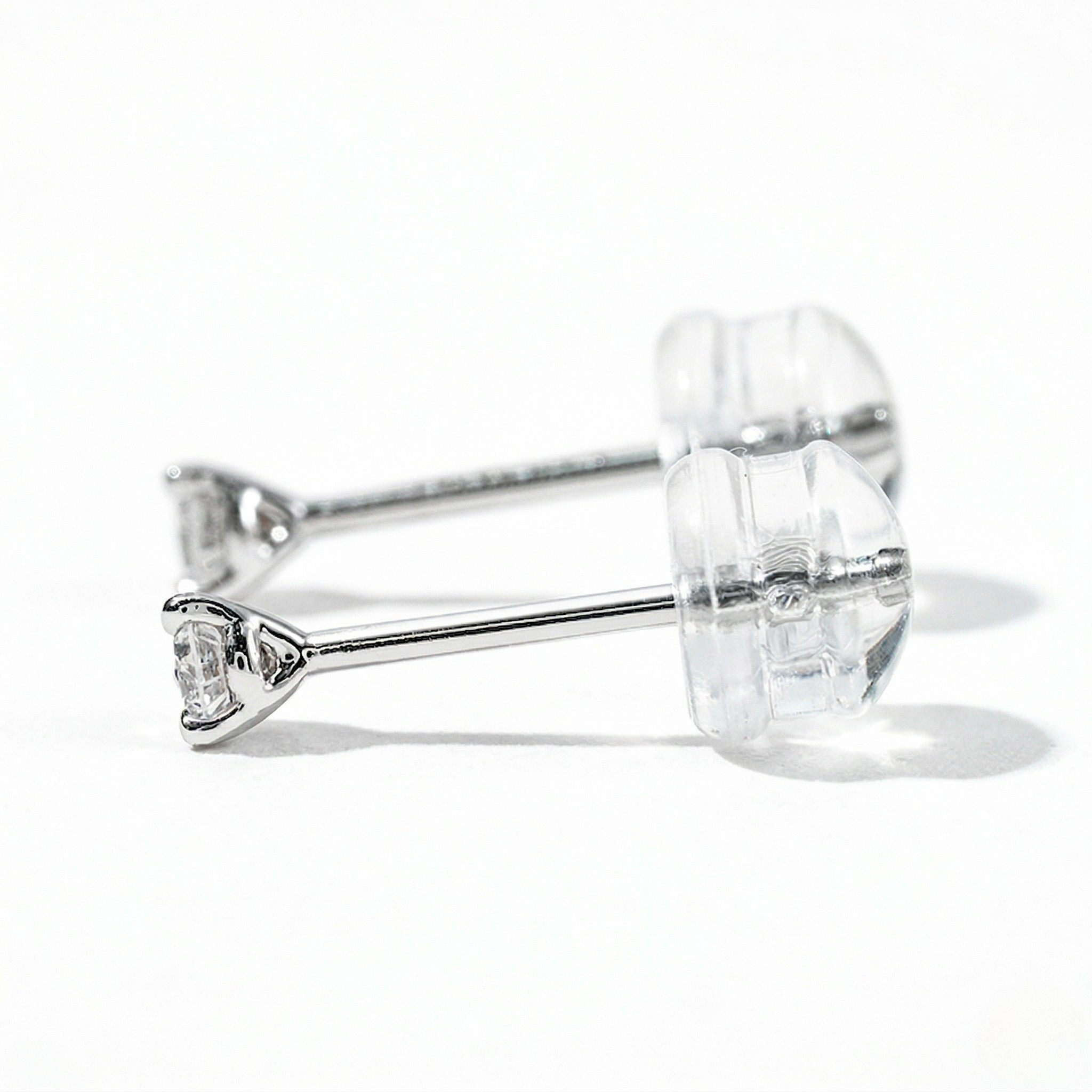 White gold round diamond solitaire stud earrings with three-prong martini setting and silicone backings, white background - Diamond Earrings Martini  0.5oct - J. Collins Jewelry 