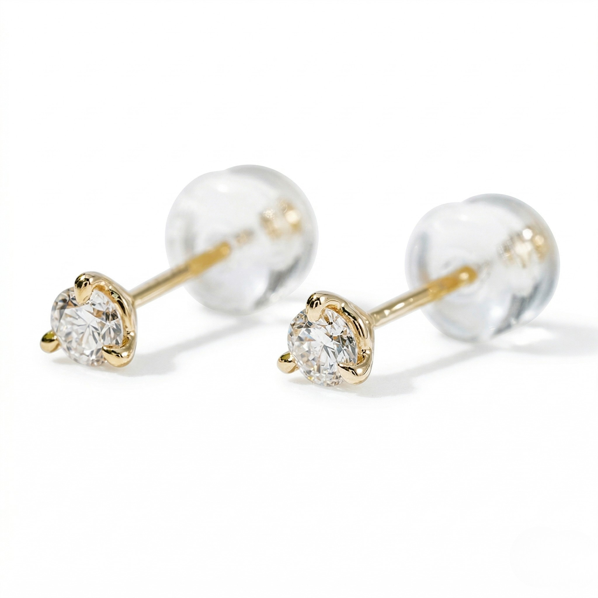 Pair of gold and clear gemstone stud earrings on a white background - Diamond Earrings Martini 0.1ct - J. Collins Jewelry 