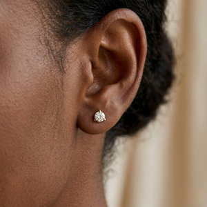 Close-up of a person wearing a diamond earring with a blurred background - Diamond Earrings Martini 0.1ct - J.  Jewelry 