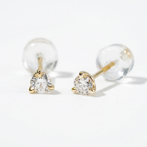 Pair of gold earrings with clear gemstones on a light gray background - Diamond Earrings Martini 0.1ct - J Collins Jewelry 