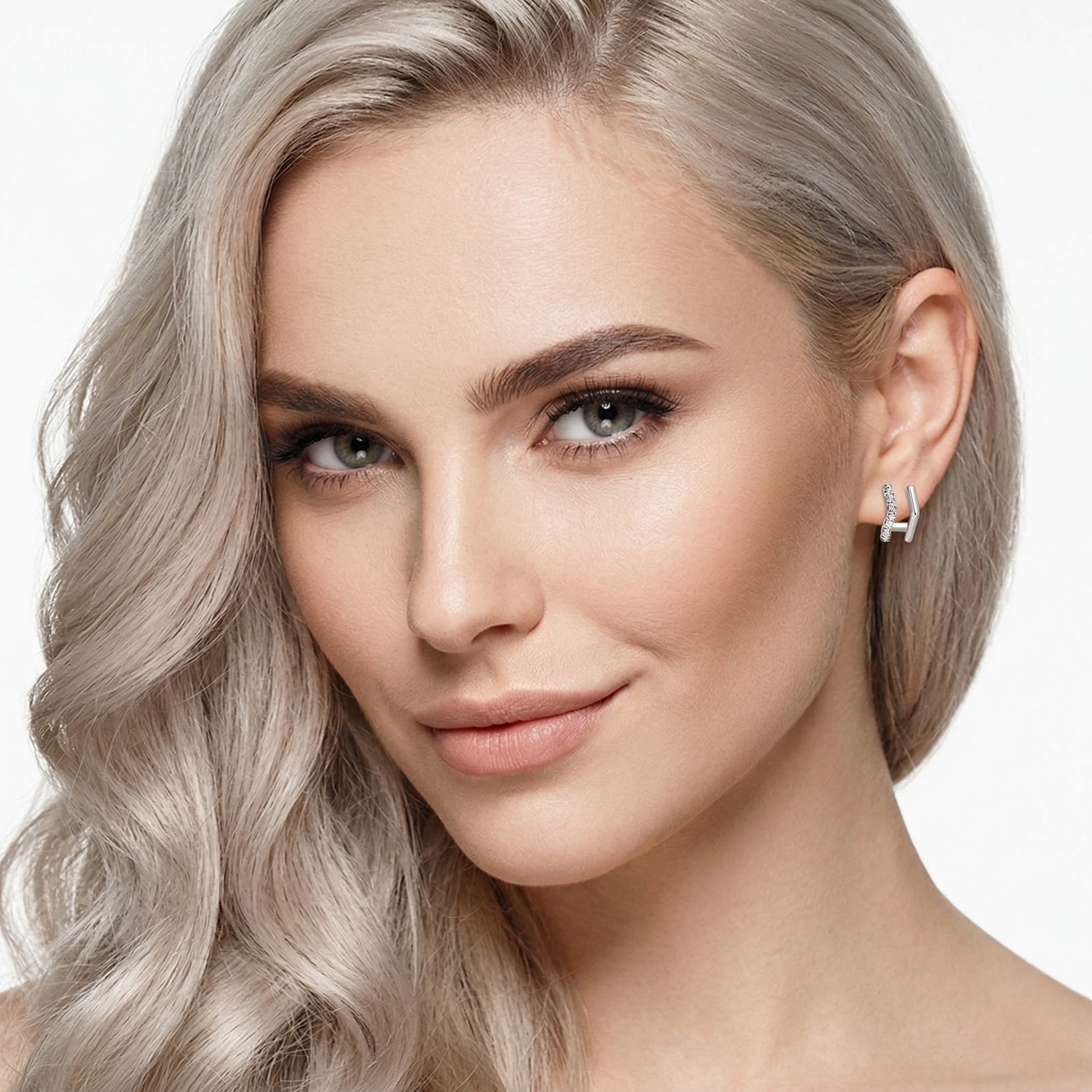 Close-up of a woman with styled hair and earrings on a white background-J.Collins Jewelry