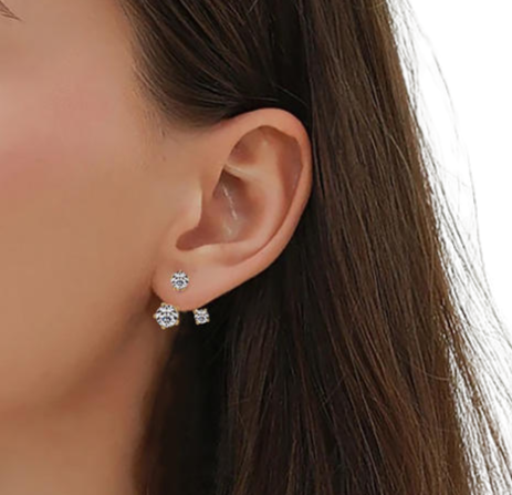 Close-up of an ear wearing two diamond stud earrings with a blurred background-J.Collins Jewelry