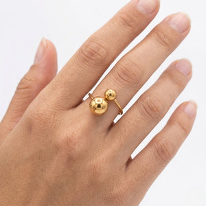 Model  wearing a contemporary gold open ring with dual sphere beads on her middle finger | J.Collins Jewelry