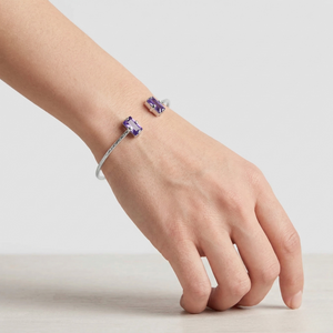 Hand wearing bracelet with purple gemstones on a light background-J.Collins Jewelry