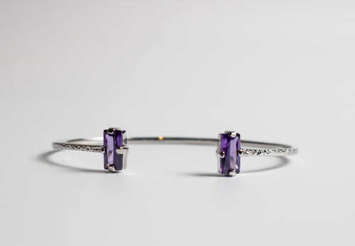 Silver bracelet with purple gemstones on a light gray background - Duara Cuff Bracelet - JCollins Jewelry  