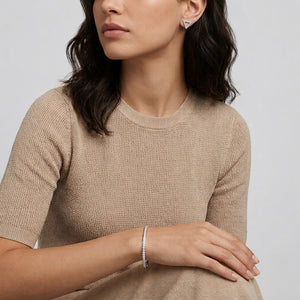 Woman wearing open triangle stud earrings with matching tennis bracelet - J.Collins Jewelry