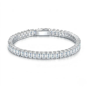 Classic single-row sterling silver tennis bracelet set with emerald-cut cubic Moissanite crystals and a secure box clasp shown on a plain white background by J.Collins
