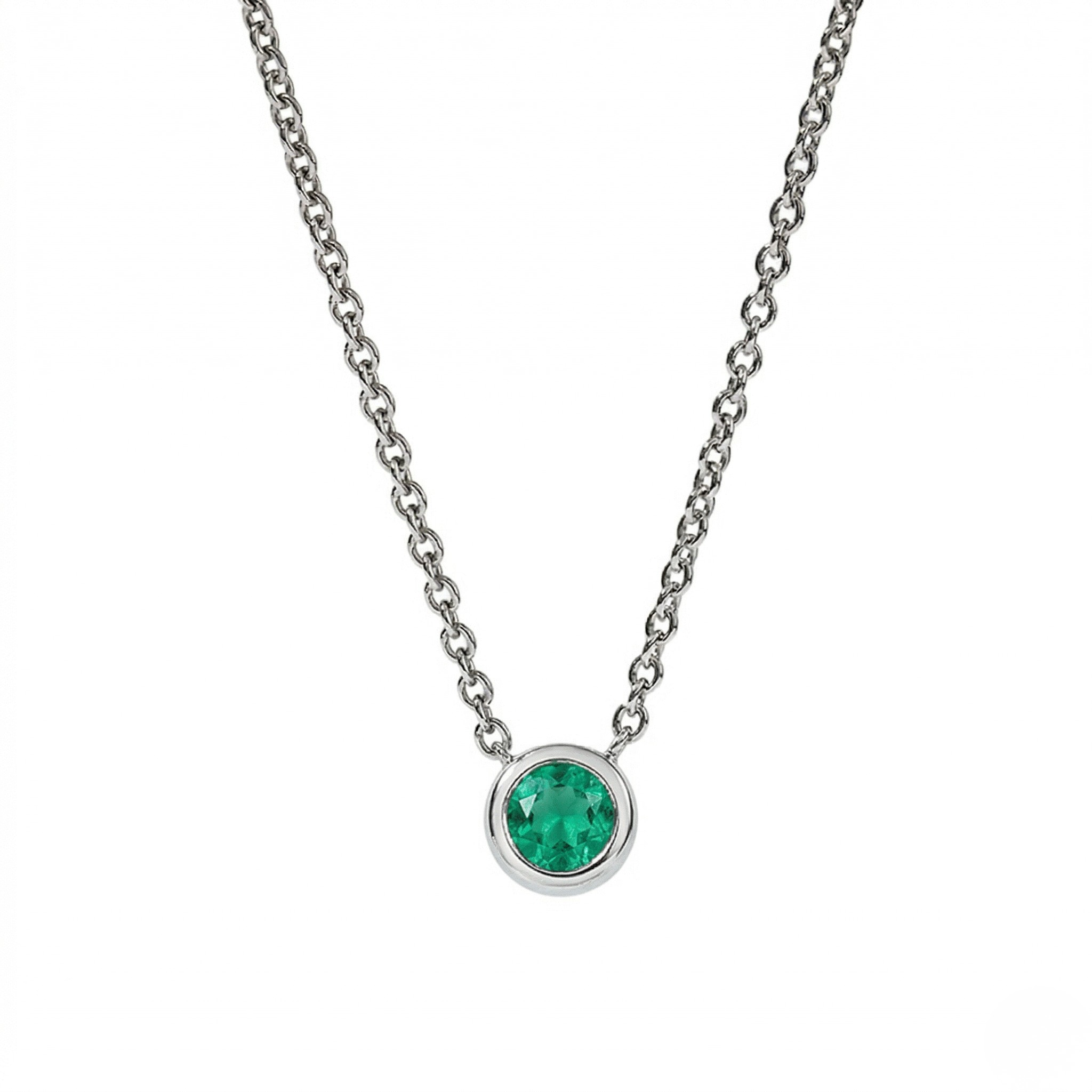 Silver necklace with a green gemstone pendant on a white background - Emerald Ne Bezel - J. Collins Jewelry 